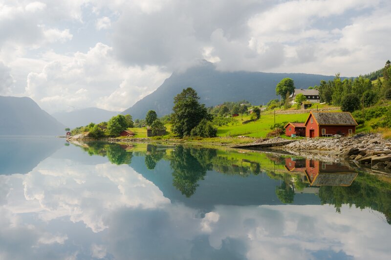 Red Cabin on Fjord Shore