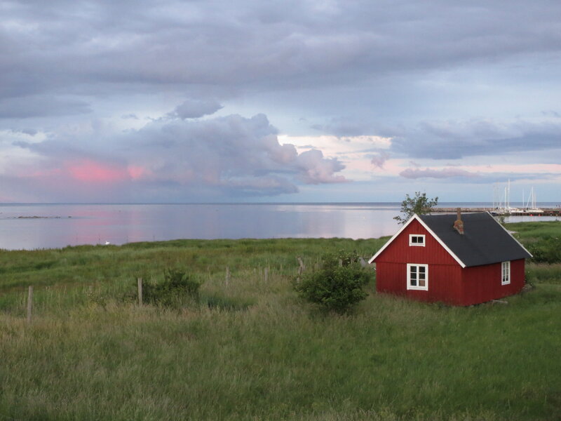 Red Cabin on Grassy Shore