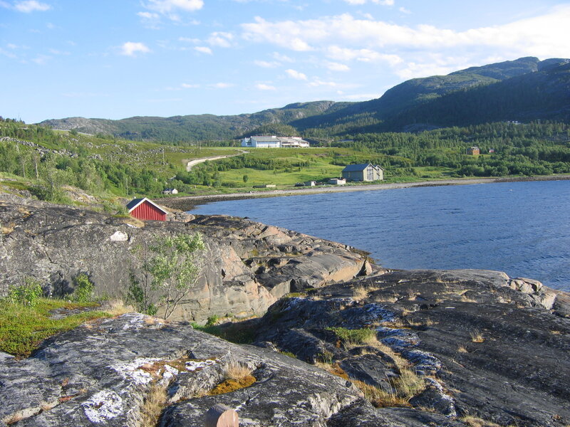 Red Cabin on Rocky Shore — Blue
