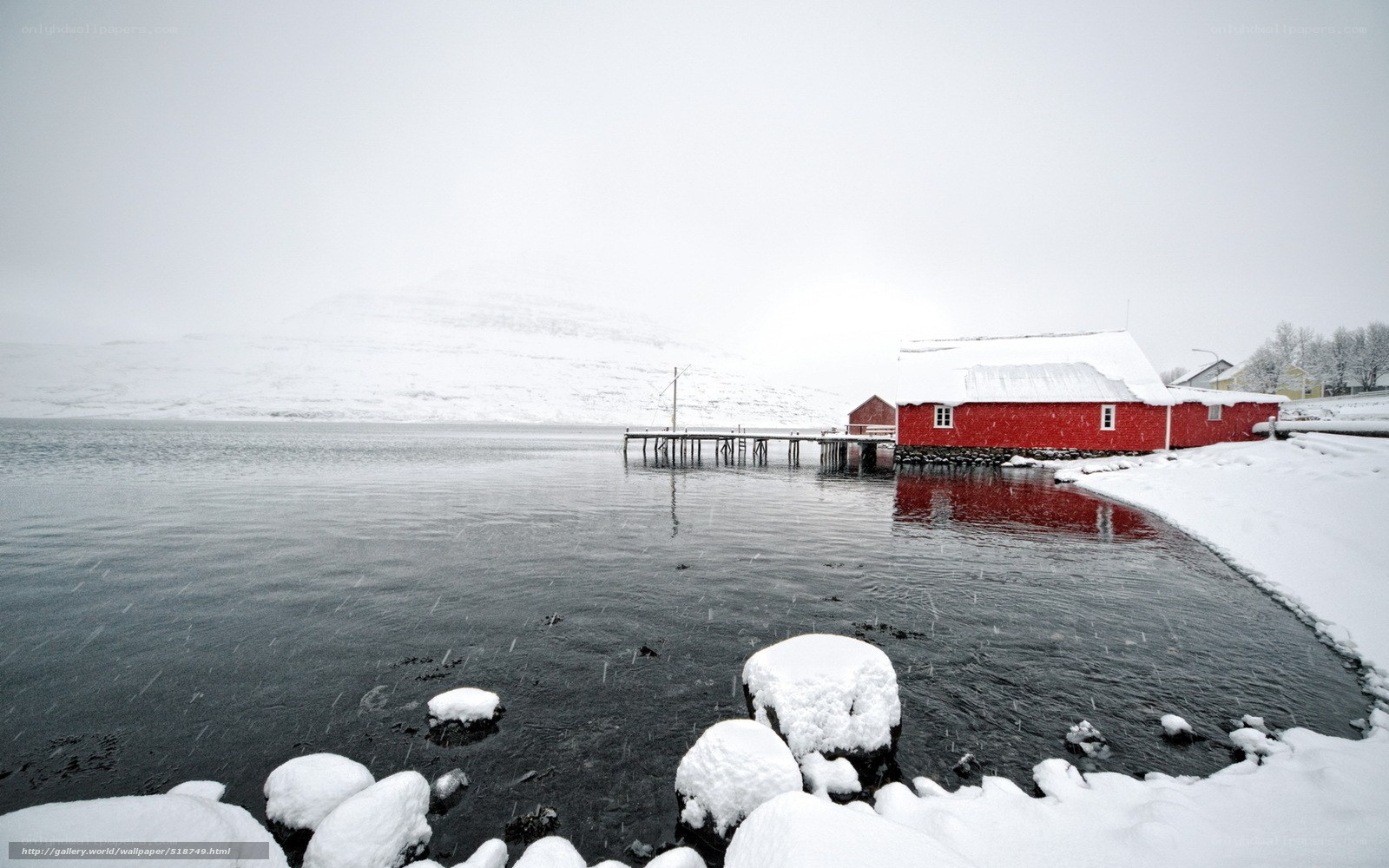 Red cabin on snowy shore