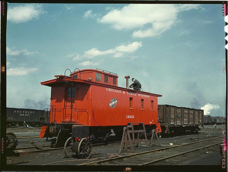 Red caboose at rail yard