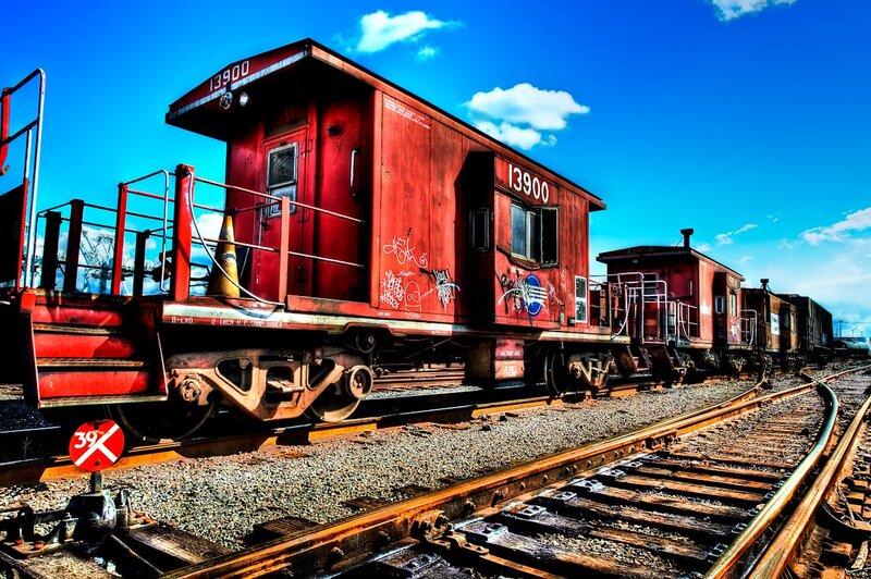 Red caboose on train tracks