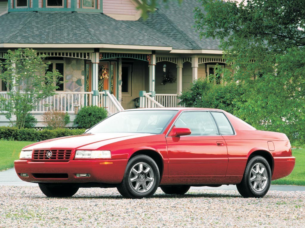 Red Cadillac Coupe in Front Yard