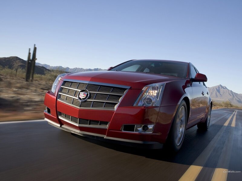 Red Cadillac driving on desert road