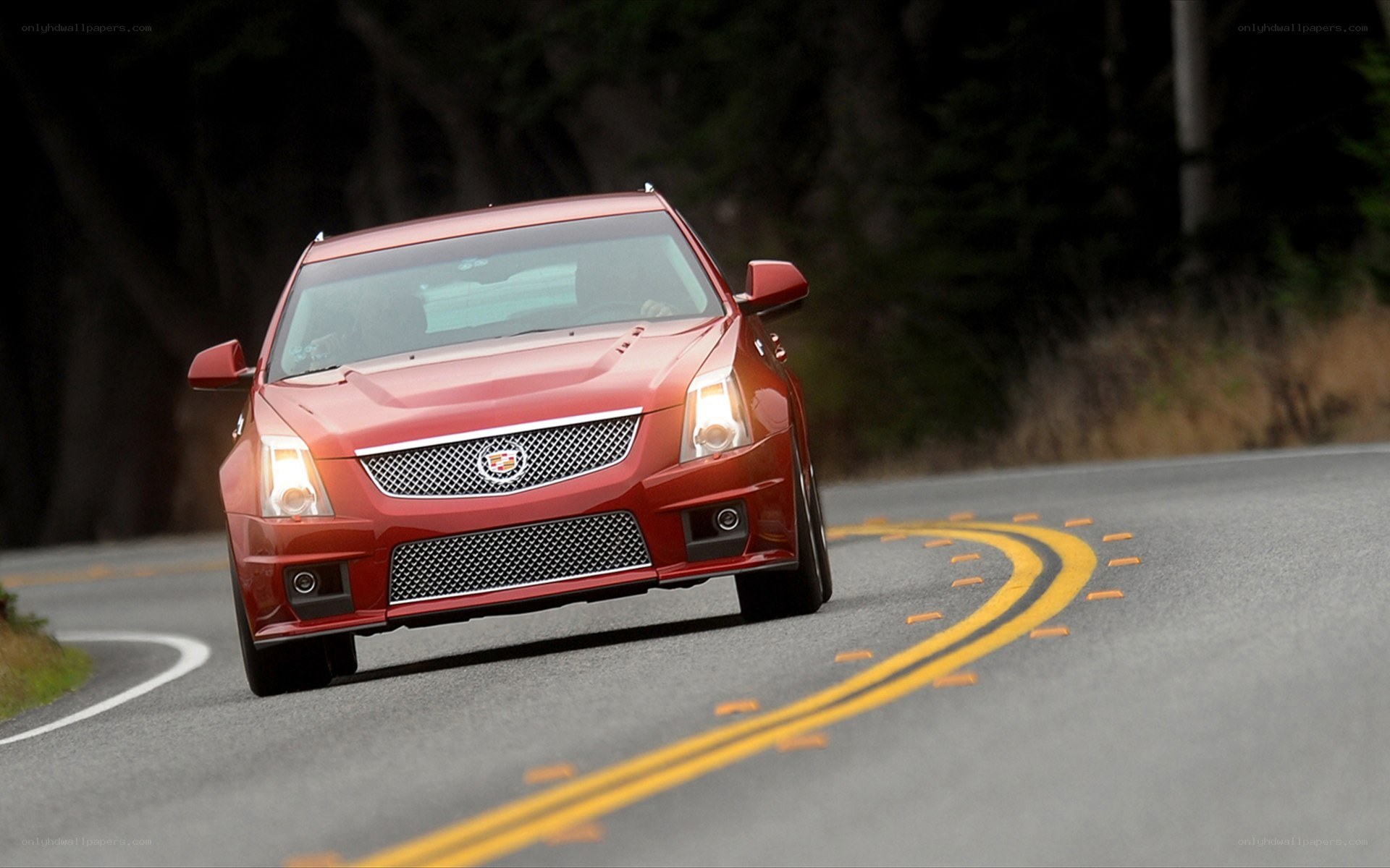 red cadillac on winding road