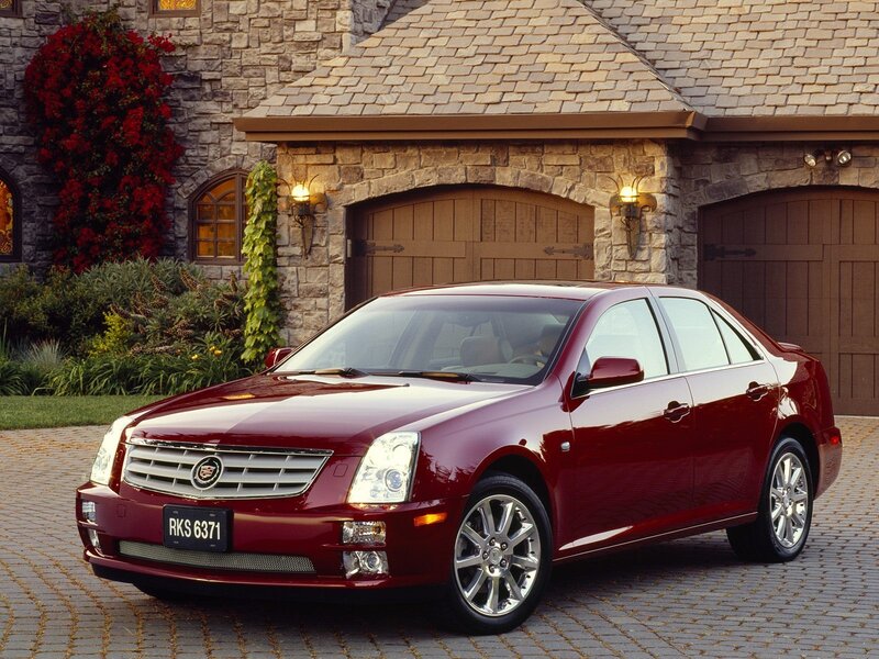 Red Cadillac parked in driveway