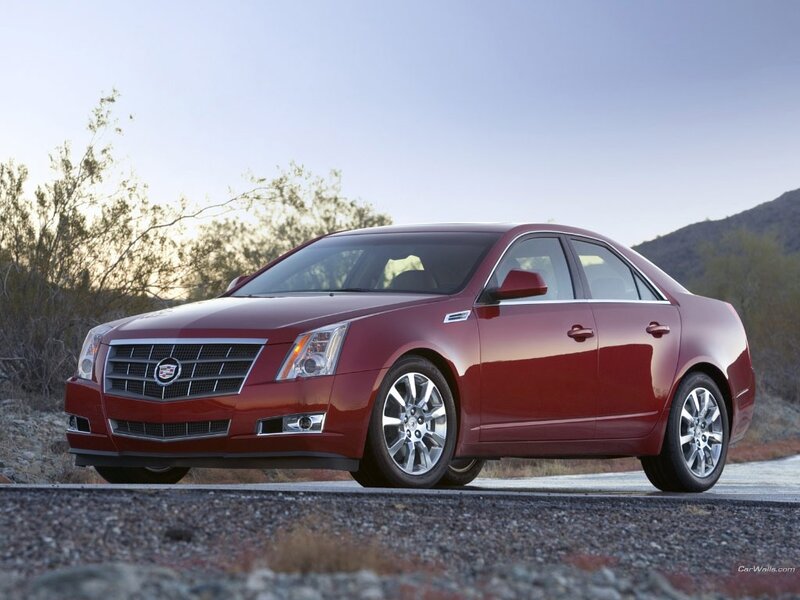 red cadillac sedan on road