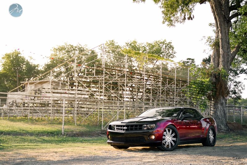 Red Camaro at a racetrack