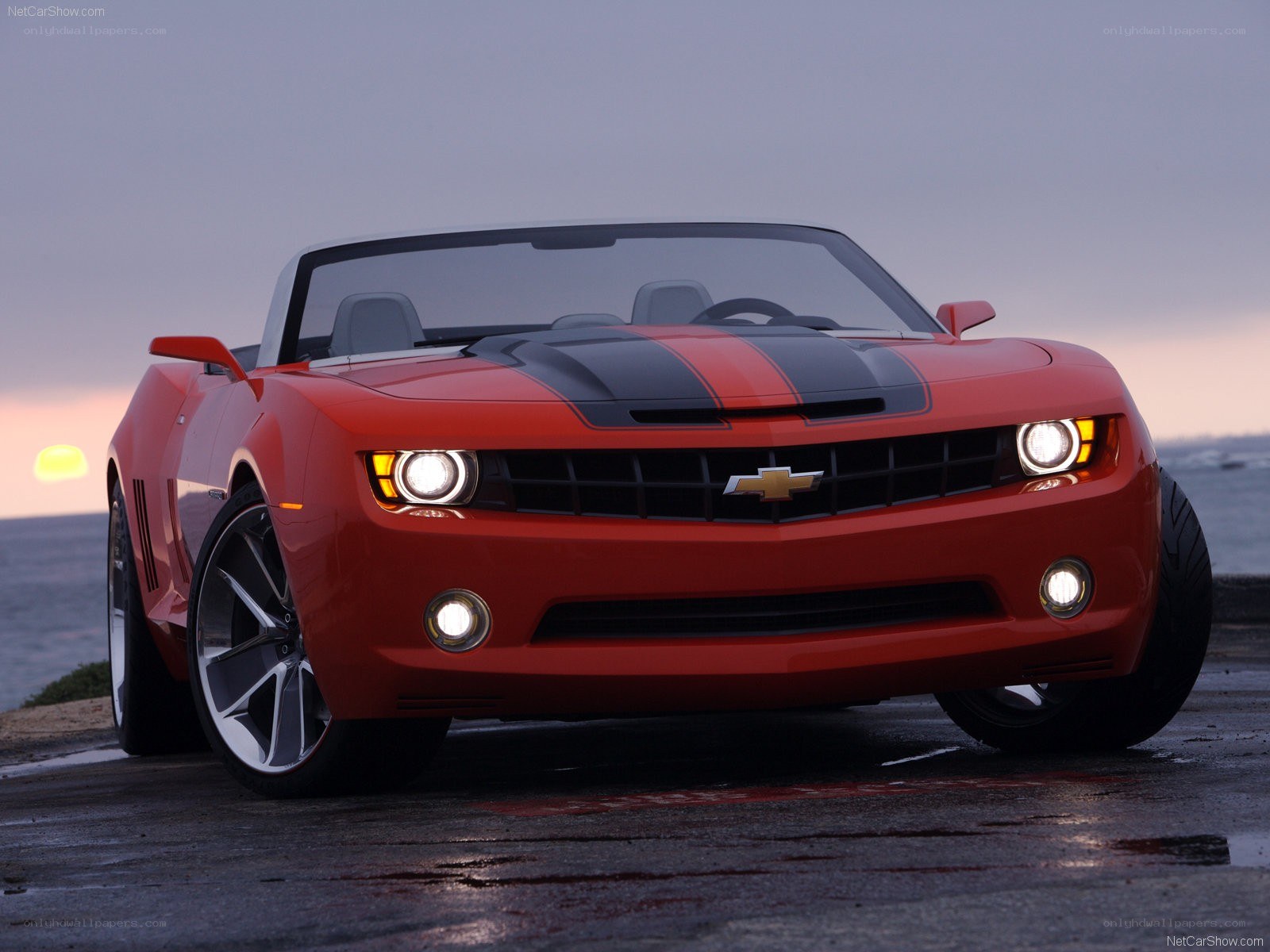 Red Camaro convertible at sunset