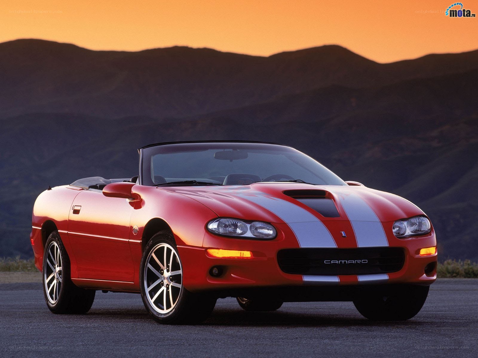 Red Camaro convertible at sunset