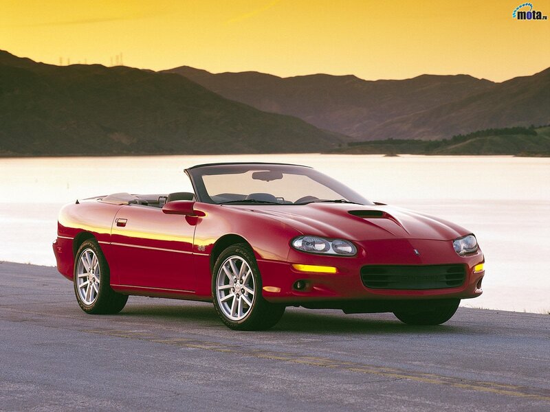 Red Camaro convertible by lake