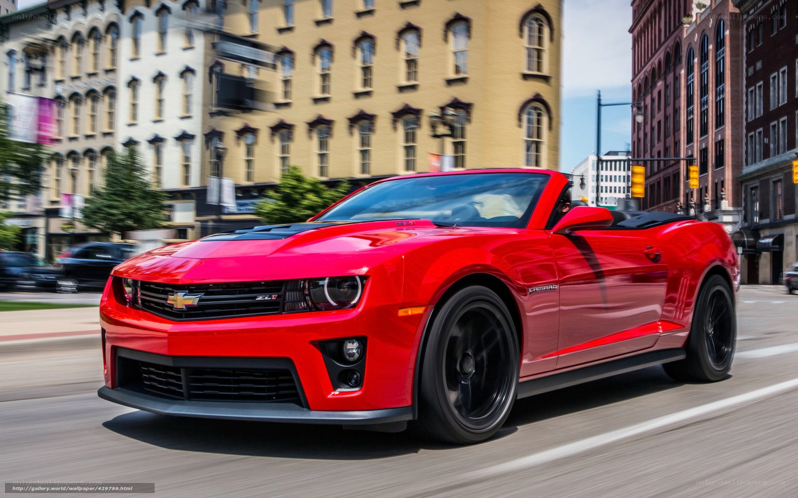 Red Camaro convertible in city