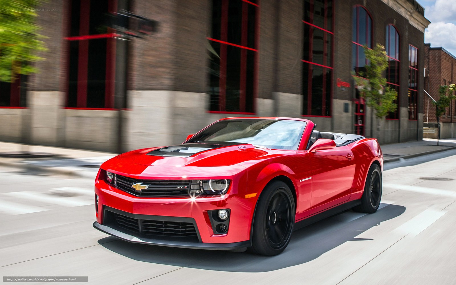 Red Camaro convertible in motion