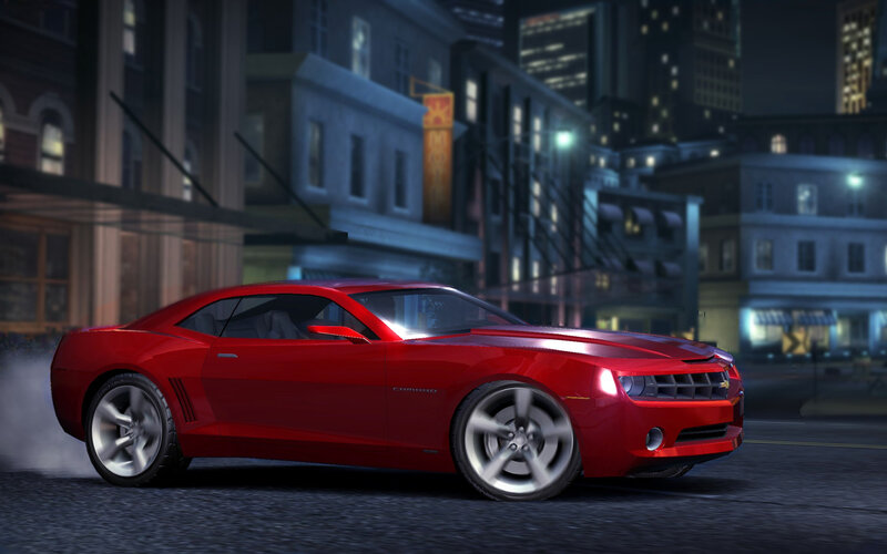 Red Camaro in city at night