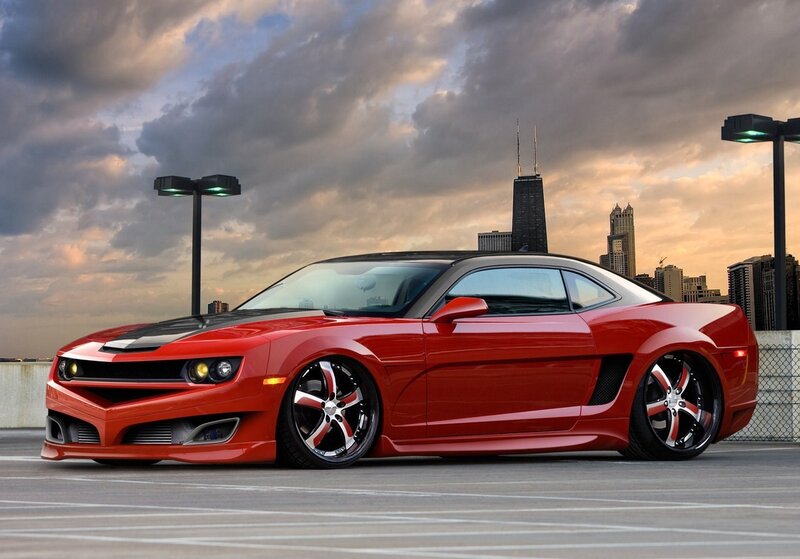 Red Camaro in city parking lot