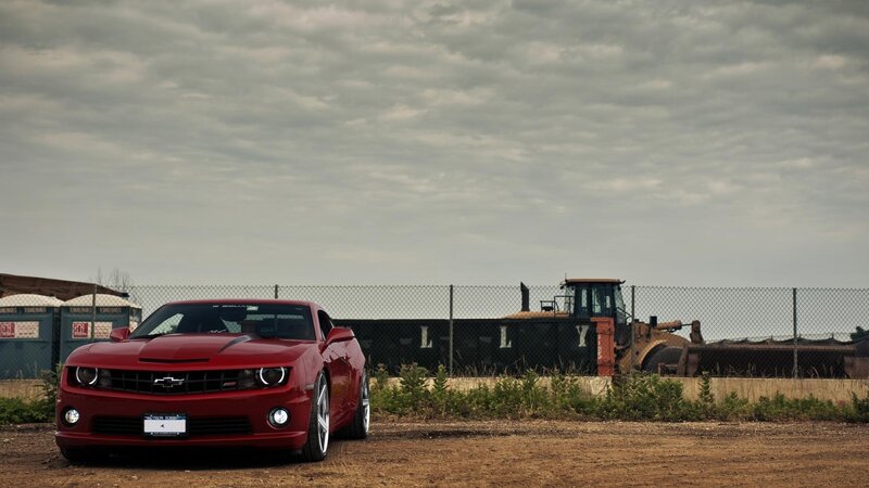 Red Camaro in industrial lot