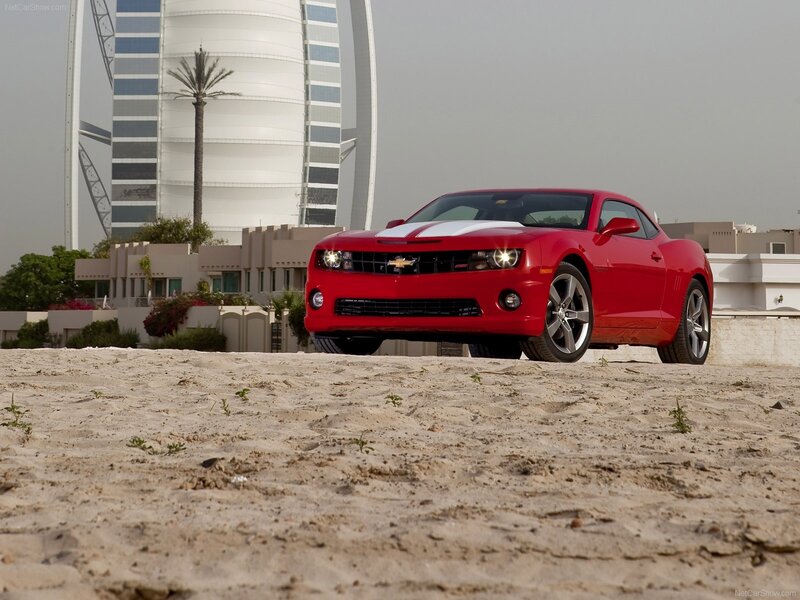 Red Camaro on a beach