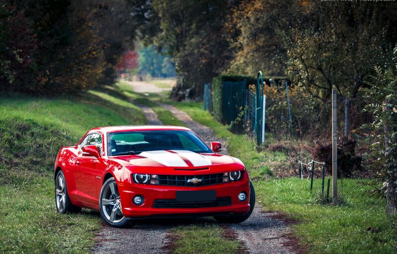 Red Camaro on a country road
