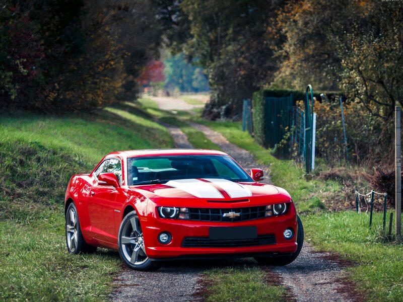 Red Camaro on a country road