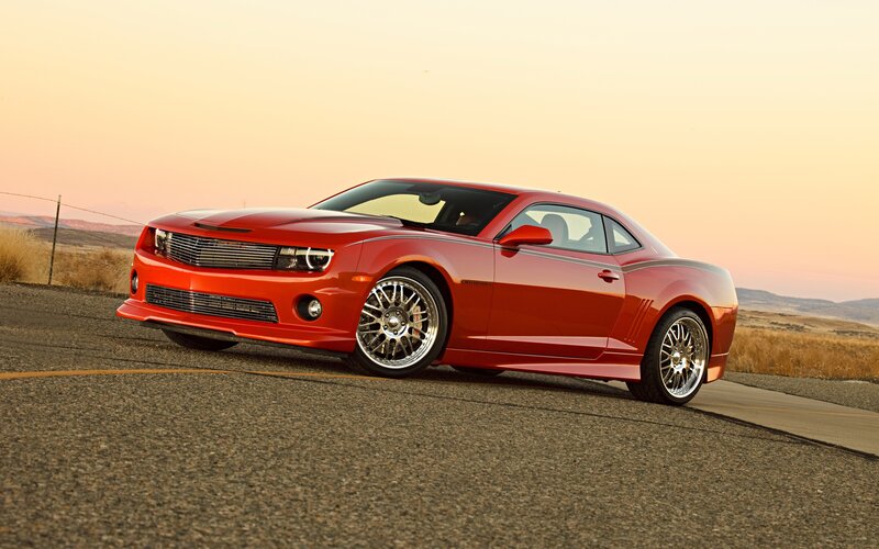 Red Camaro on a desert road