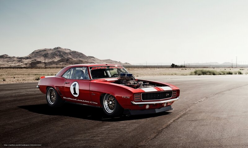 Red Camaro on a desert track