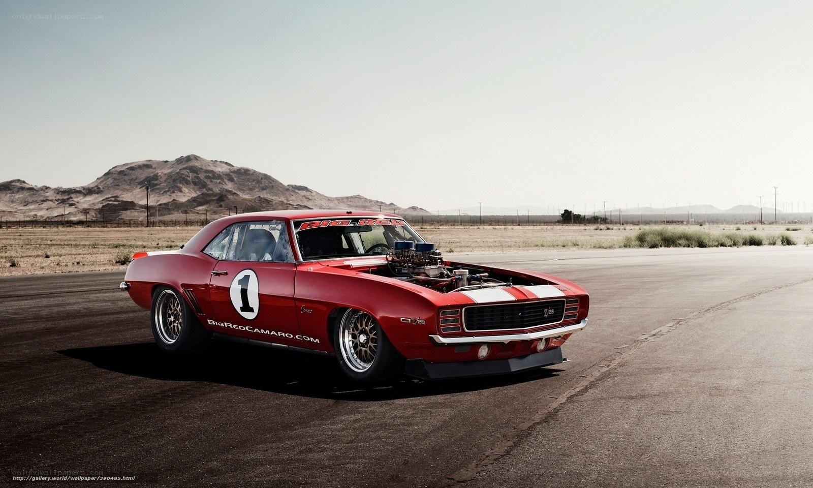 Red Camaro on a desert track