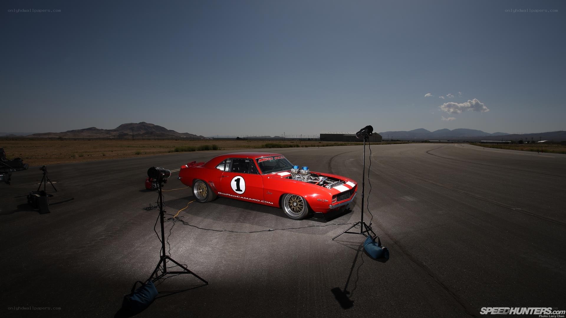 Red Camaro on a racetrack