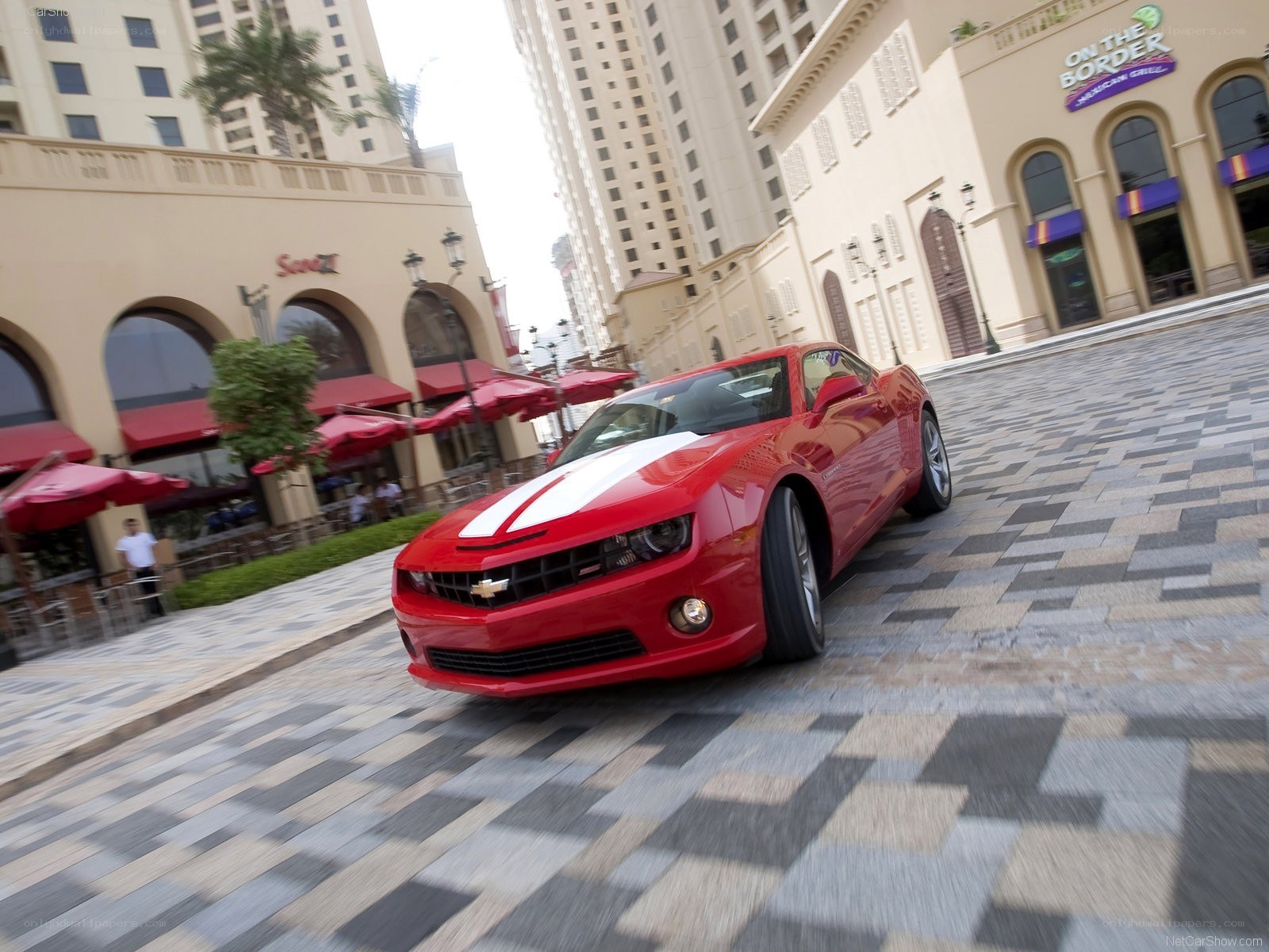 Red Camaro on city street