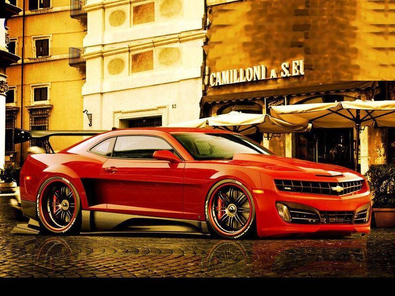 Red Camaro on cobblestone street