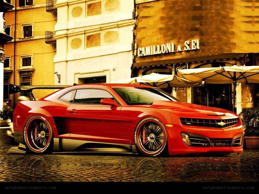 Red Camaro on cobblestone street