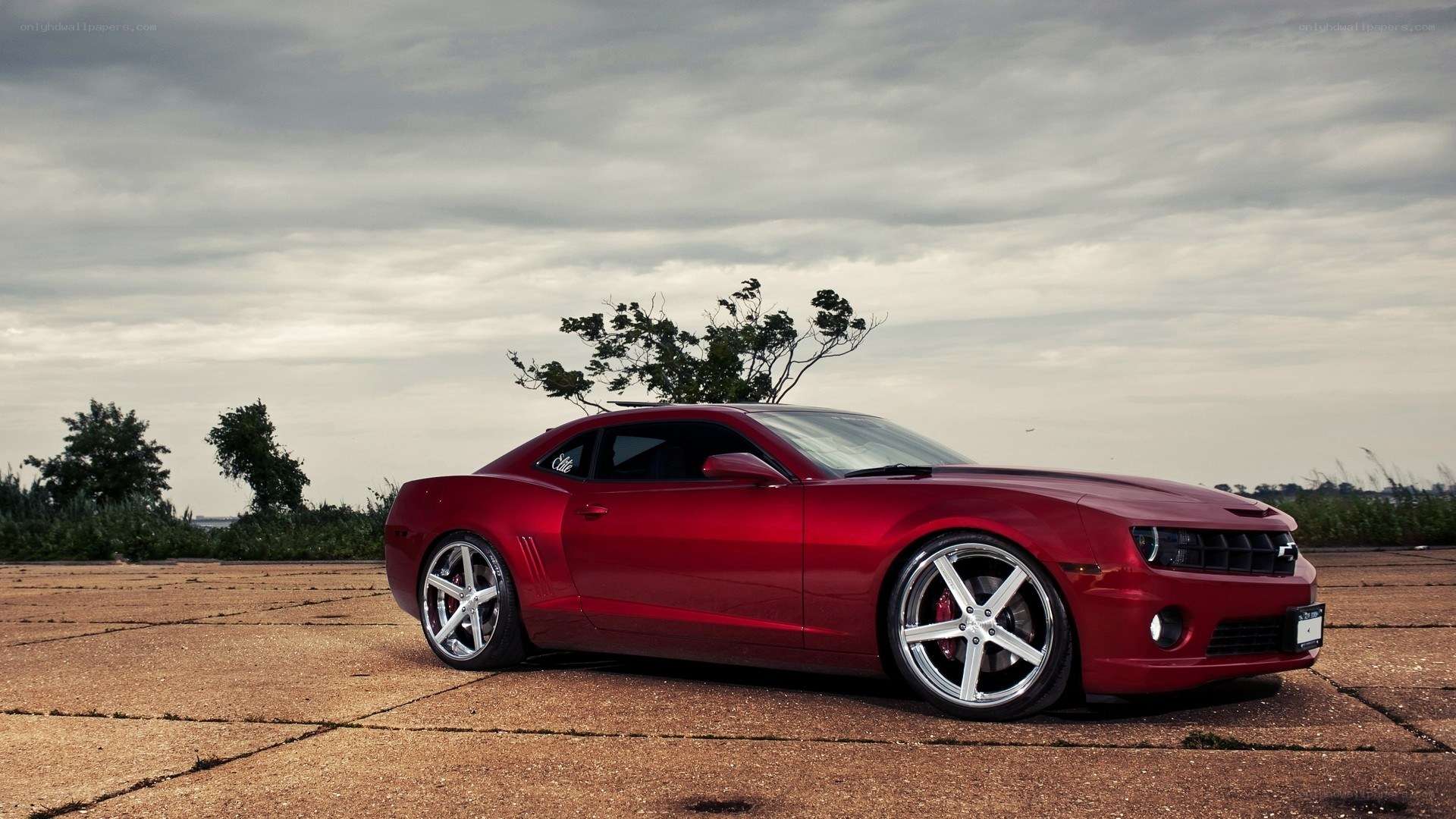 Red Camaro on concrete