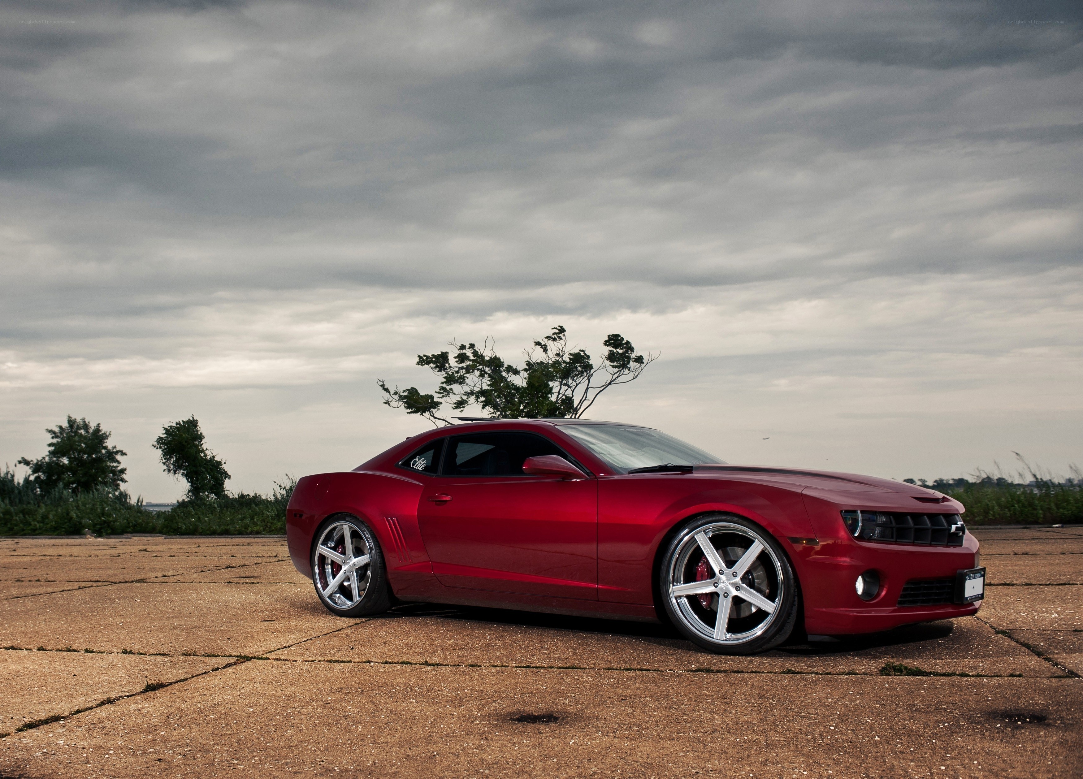 Red Camaro on concrete