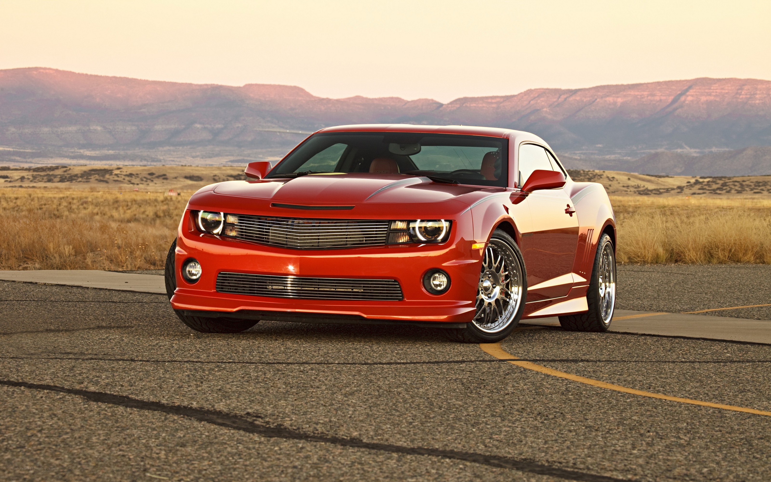 Red Camaro on desert road