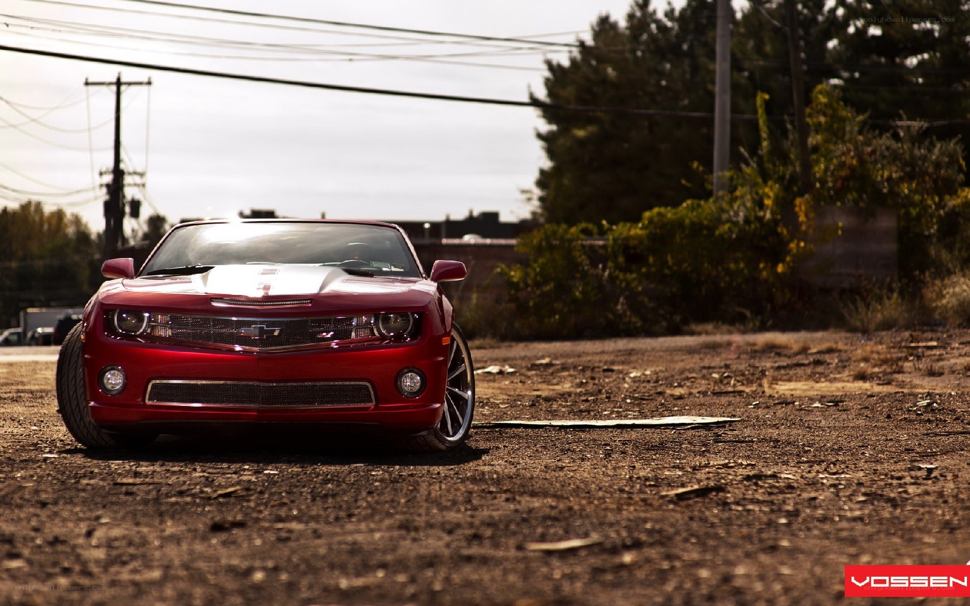 Red Camaro on dirt road