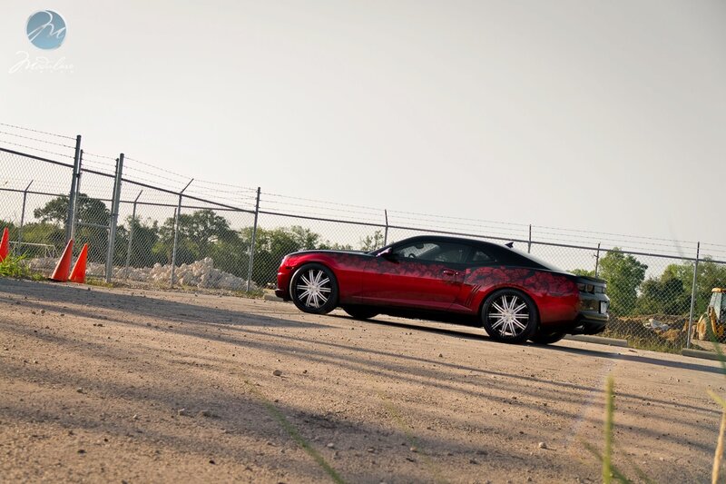 red camaro with custom wheels