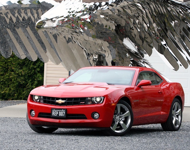 Red Camaro with eagle sculpture