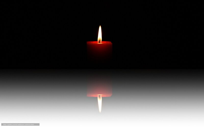 Red candle in darkness