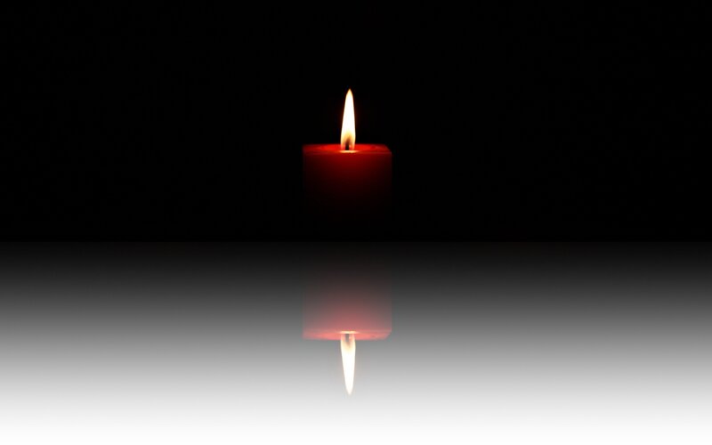 Red Candle on Reflective Surface