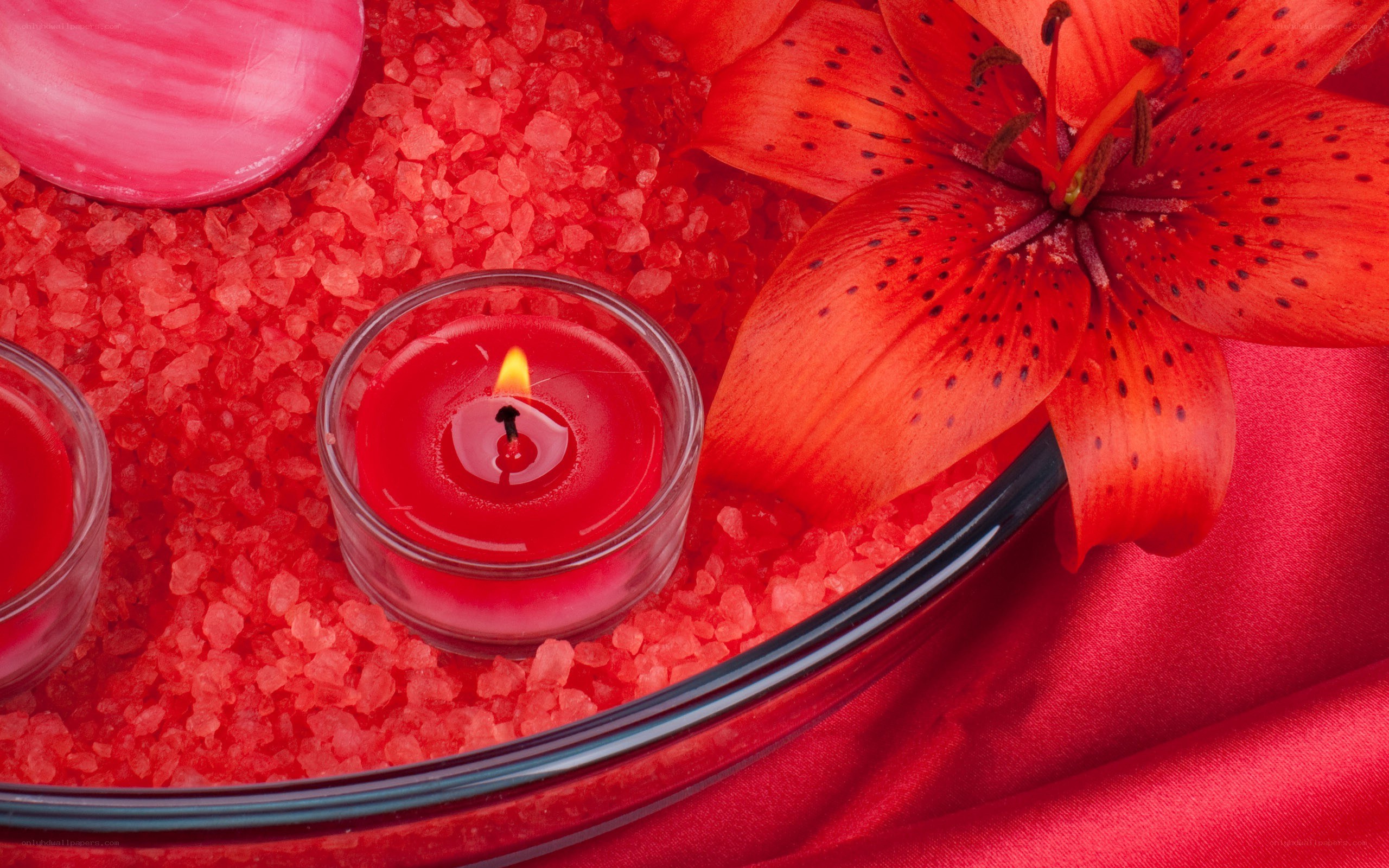 Red candle with lily flower
