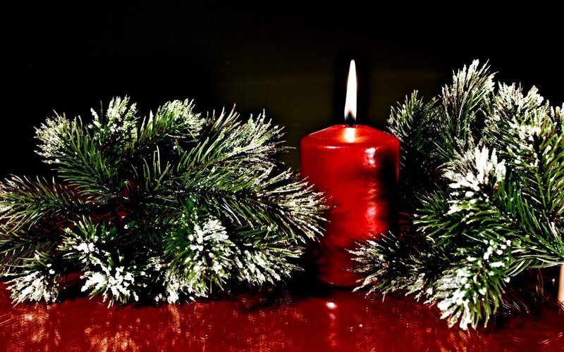 Red candle with pine branches