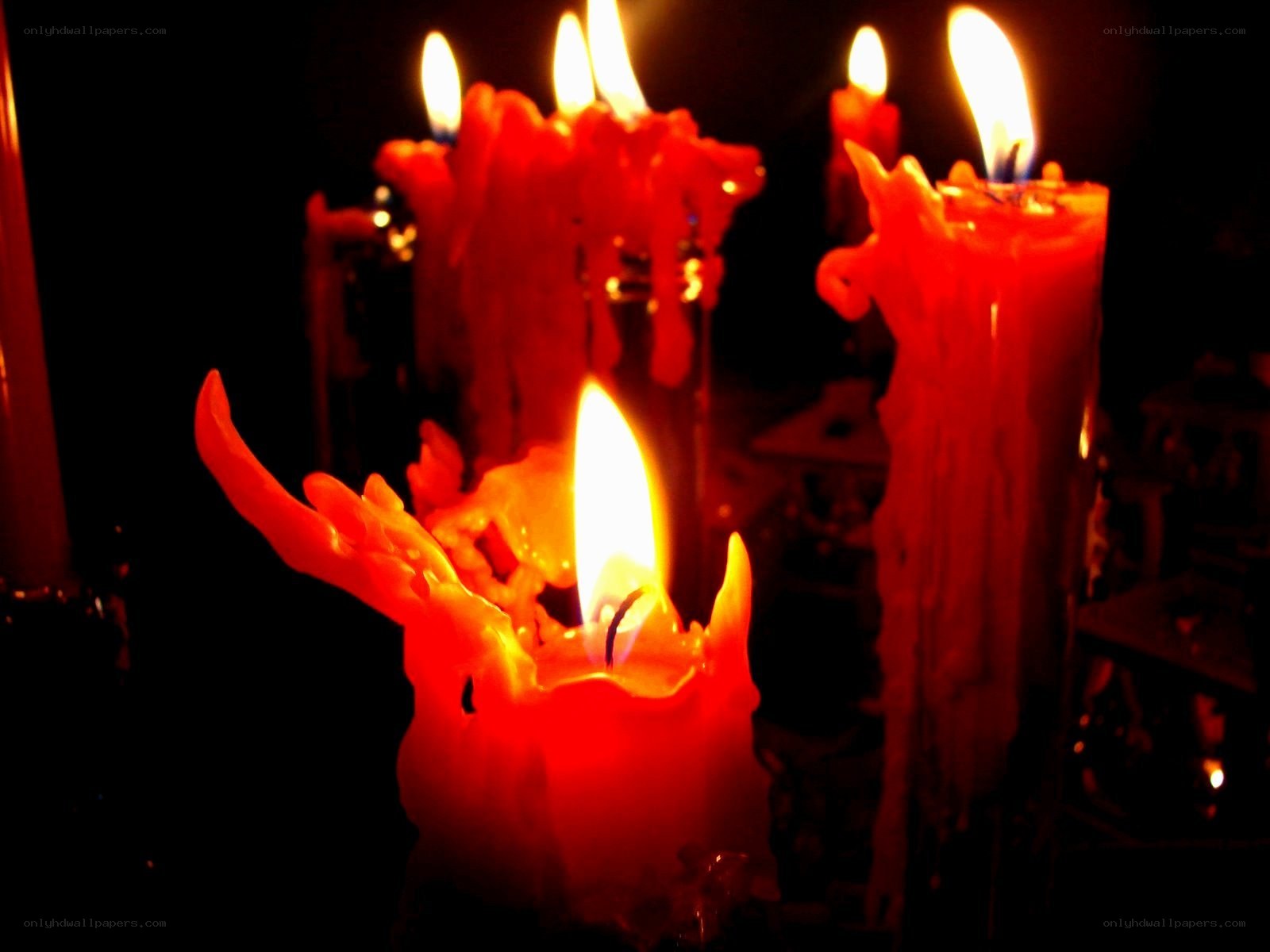Red candles burning in darkness