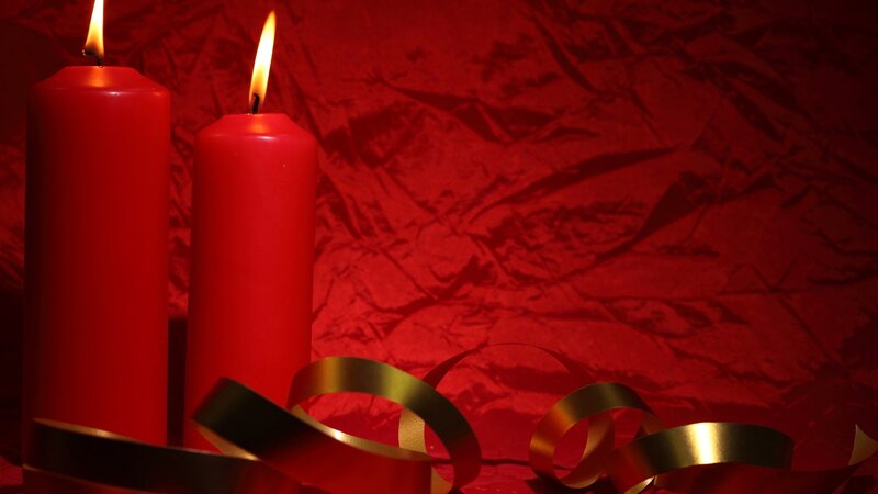 Red candles with gold ribbon