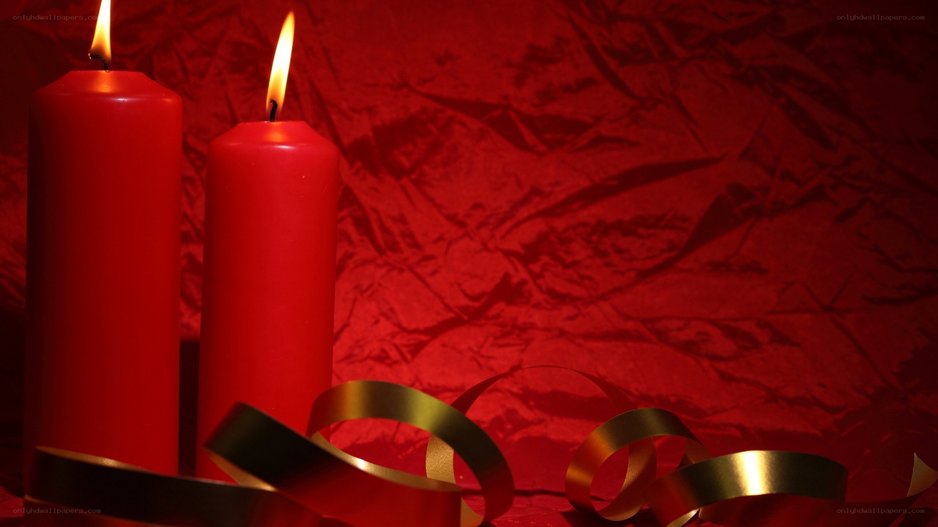 Red candles with gold ribbon