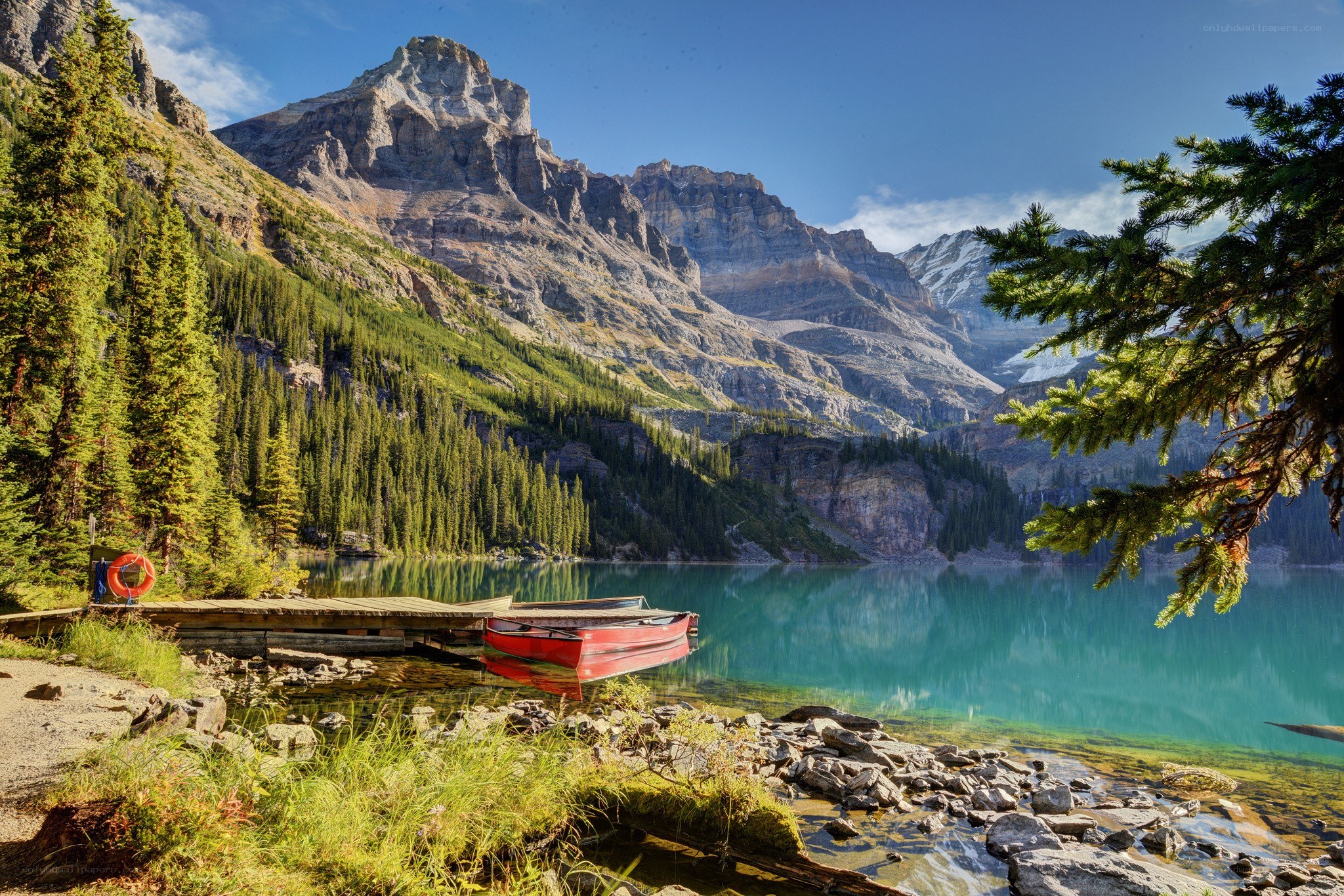 Red canoe at mountain lake