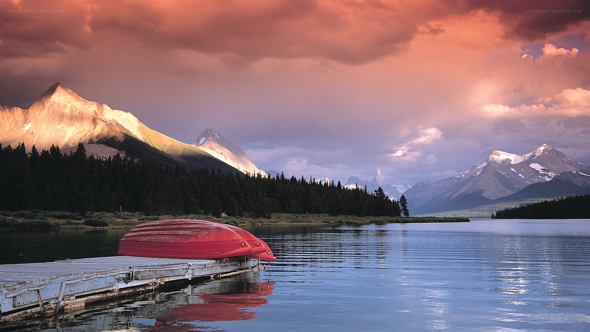 Red canoe at mountain lake