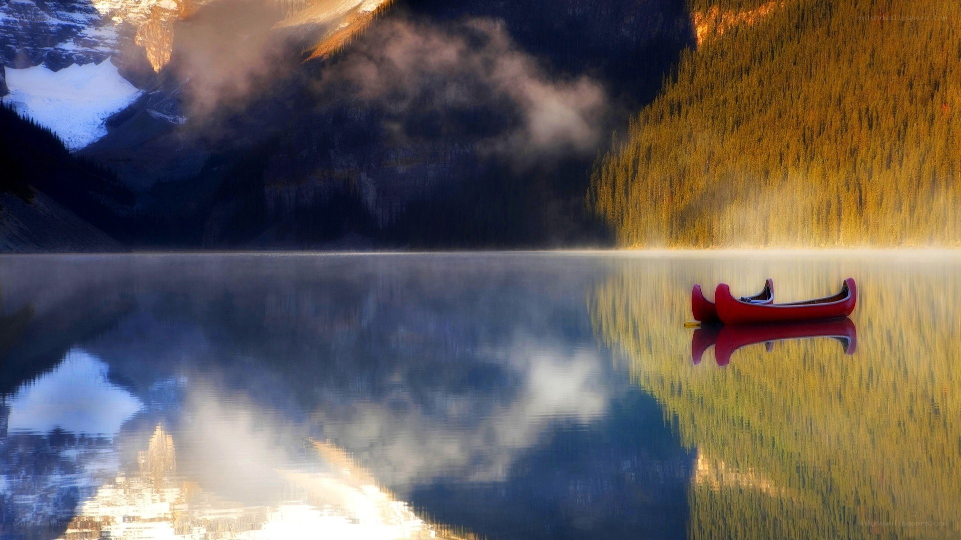 Red canoe on a misty lake