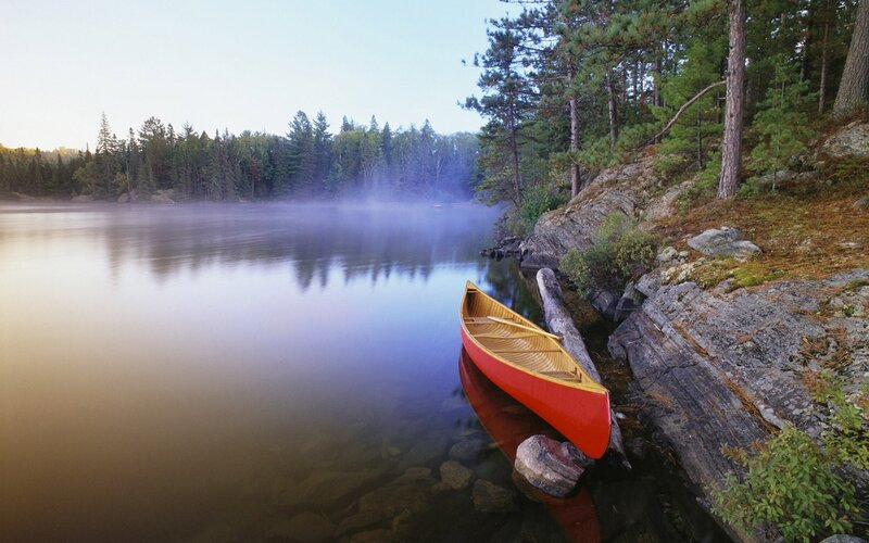 Red Canoe on Lake Shore — Serene