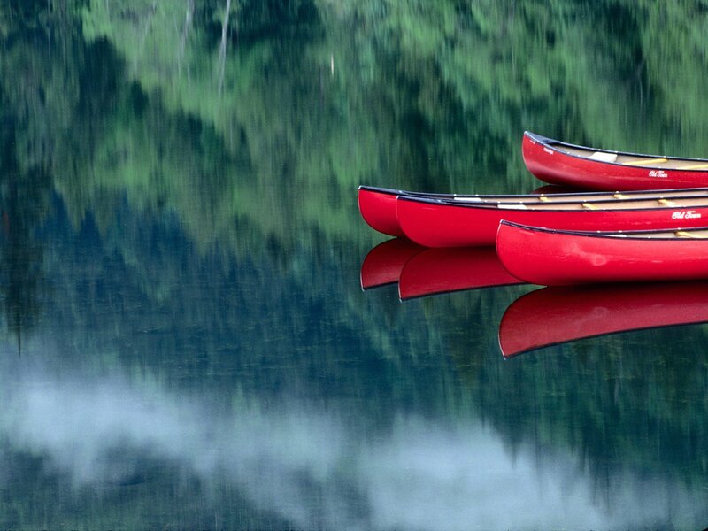 Red canoes on a misty lake