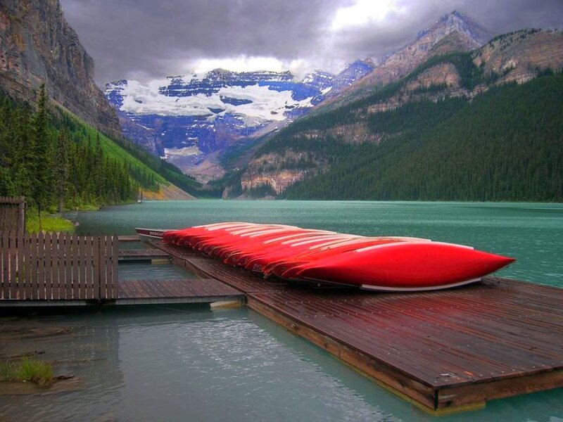 Red canoes on a wooden dock