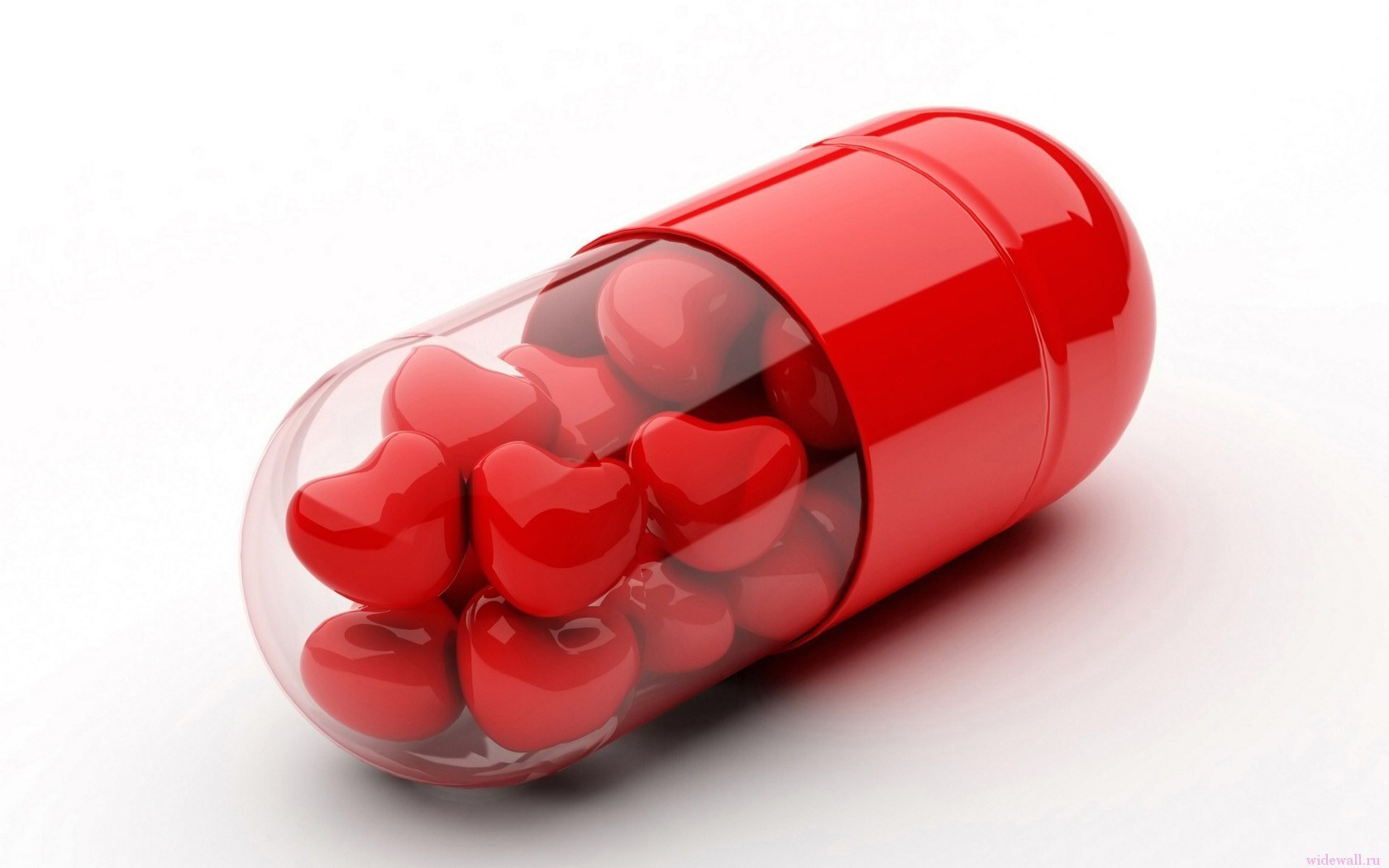 Red capsule with heart-shaped pills